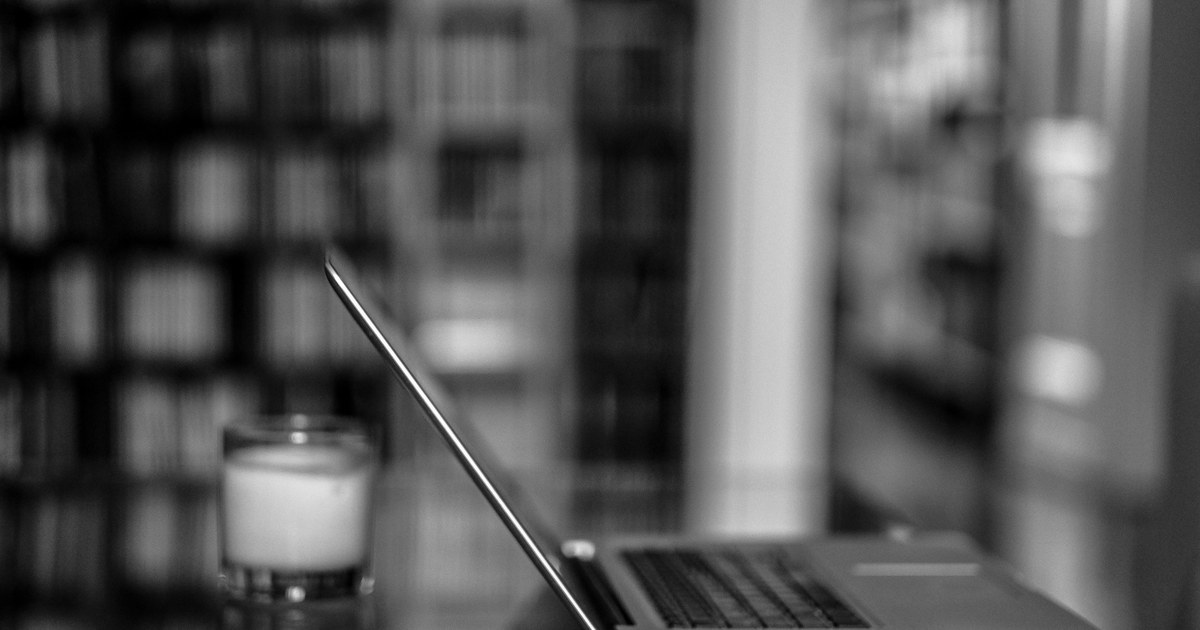 Laptop open on a desk in a library, illustrating regulated online casino gambling in New Zealand