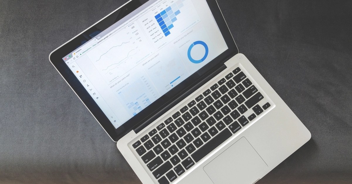 Laptop on a desk showing a dashboard with charts, representing online casino account controls