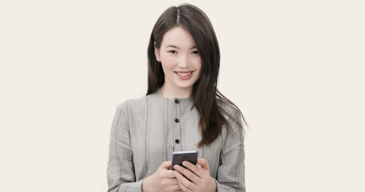 Person using a smartphone, illustrating account checks and safer gambling tools at licensed online casinos