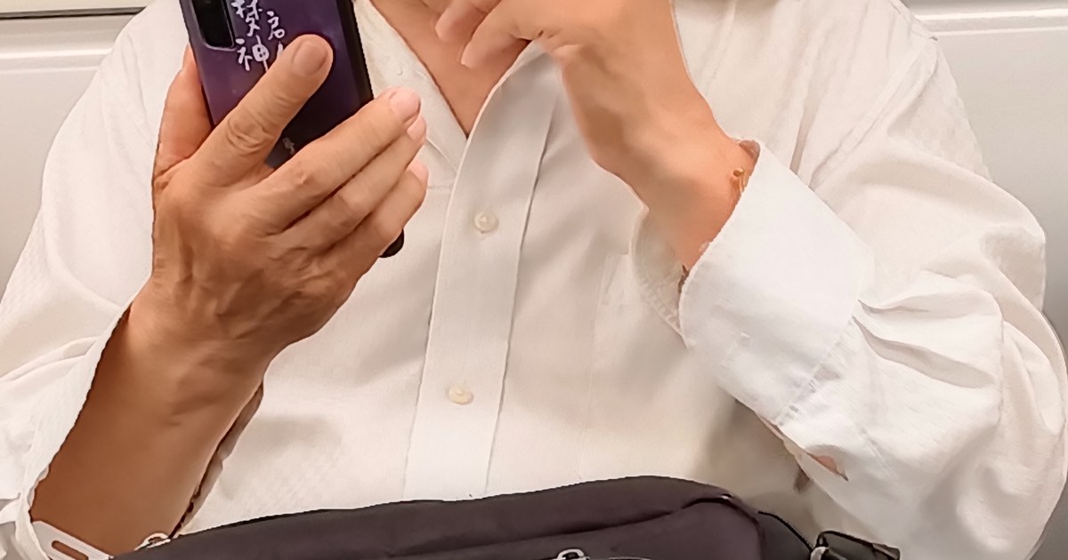 Person holding a smartphone while managing an online account