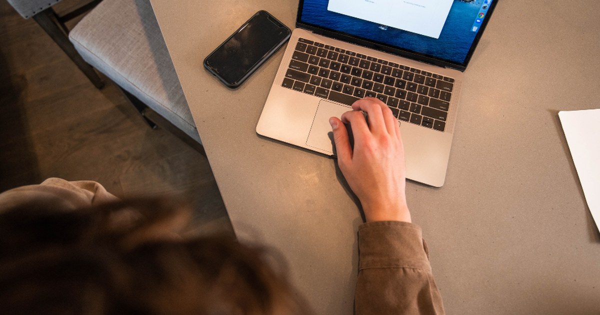 Person reviewing online casino account settings on a laptop and smartphone
