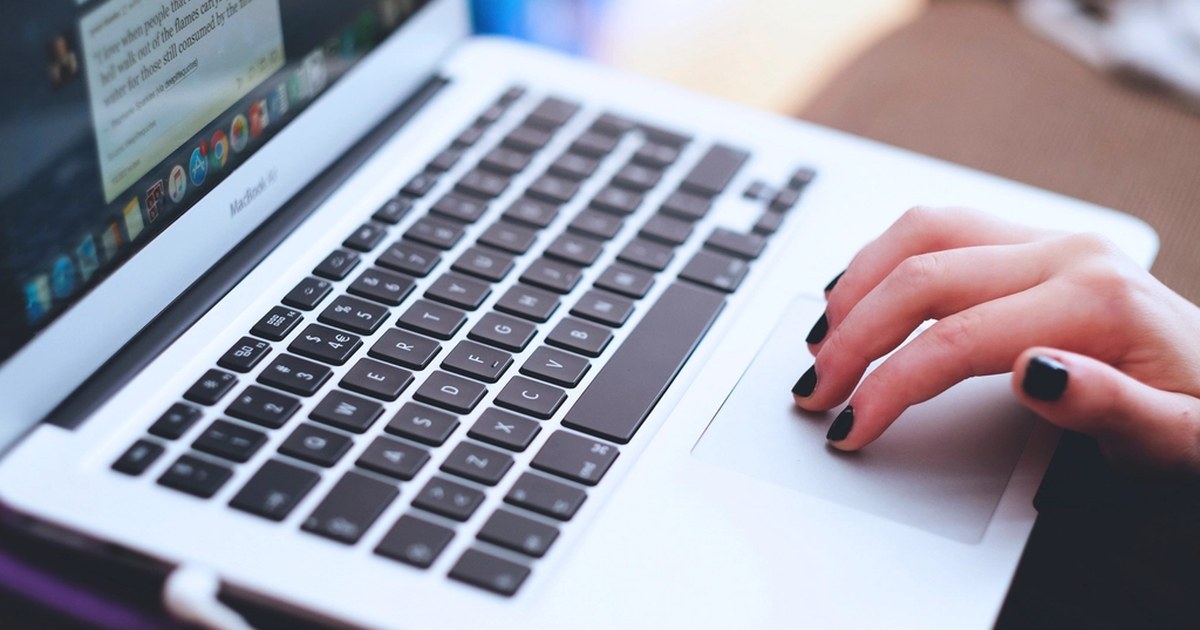 Person using a laptop to manage an online account, illustrating new UK casino deposit limit rules