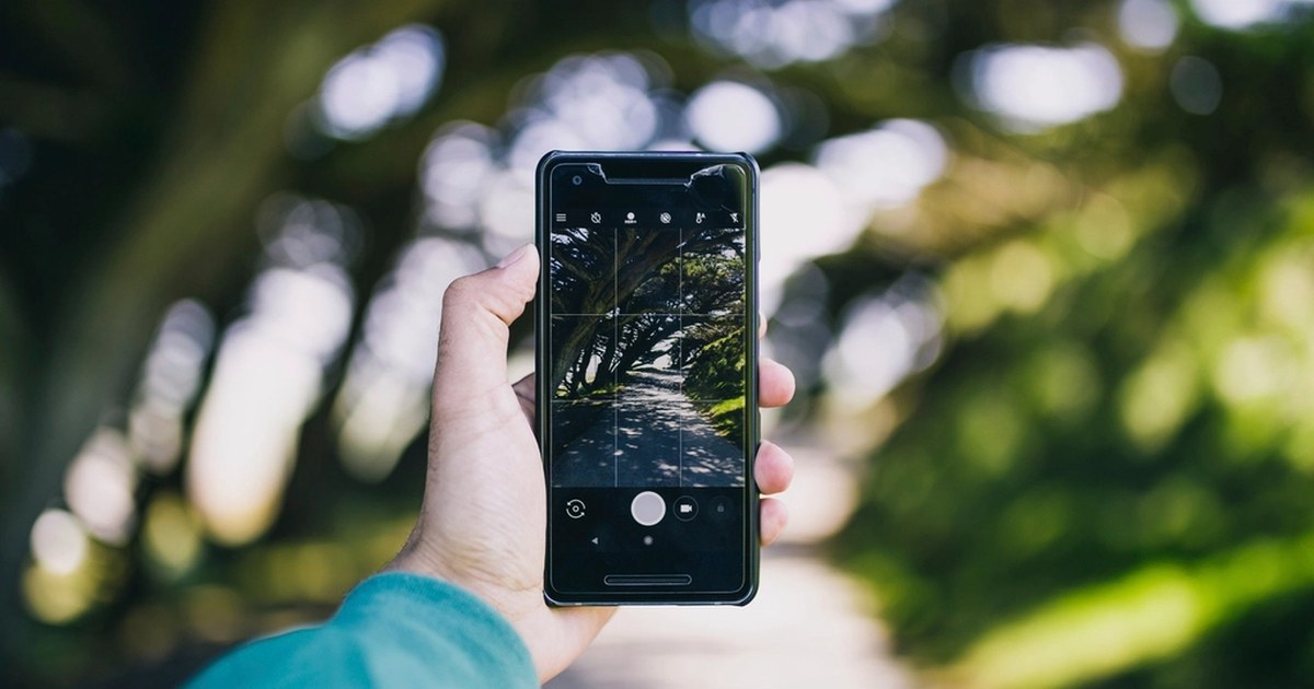Person holding a smartphone, representing online casino account and deposit limit settings